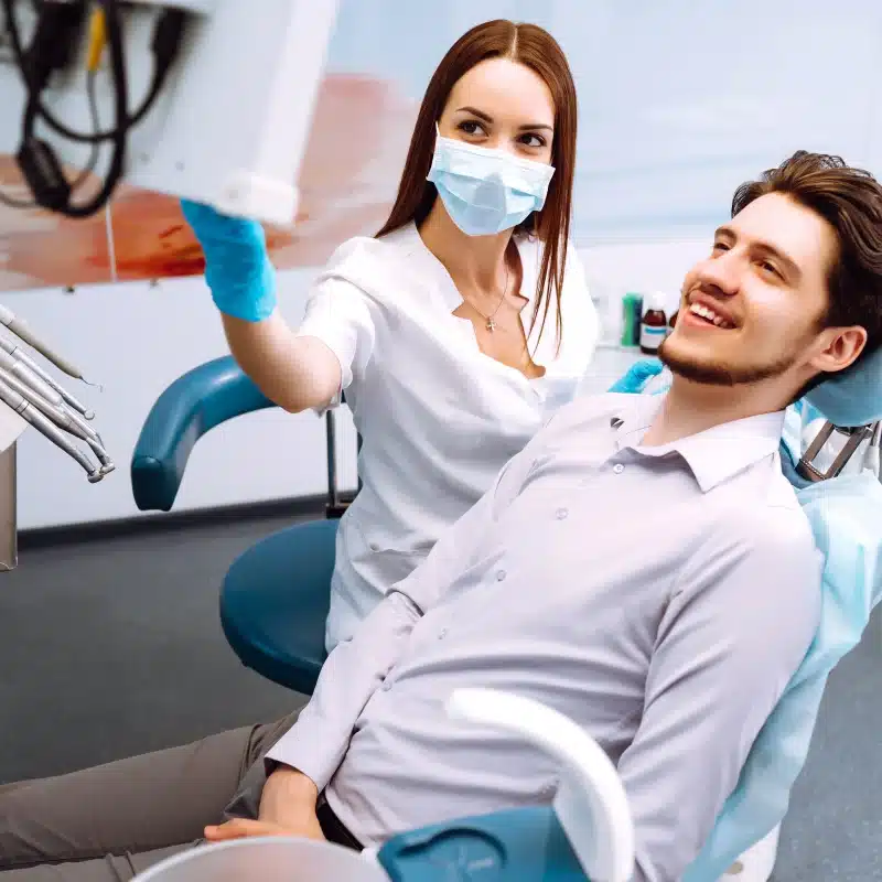 Dentist examining male patient in dental clinic for orthodontics in fernley