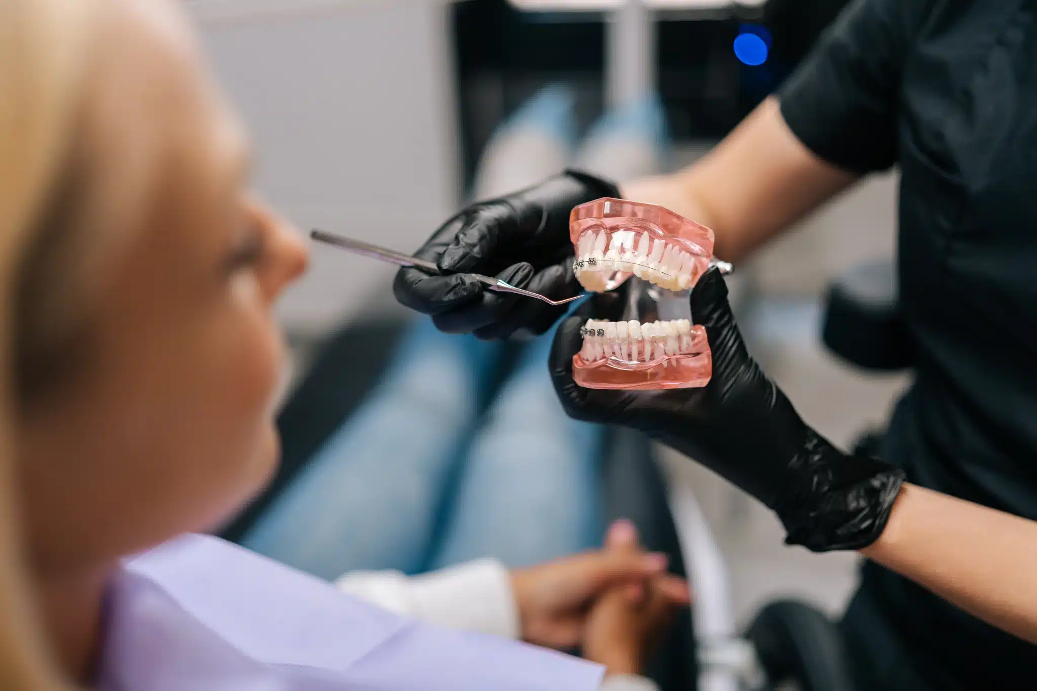 Dentist demonstrating teeth model to patient in clinic for for orthodontics in fernley