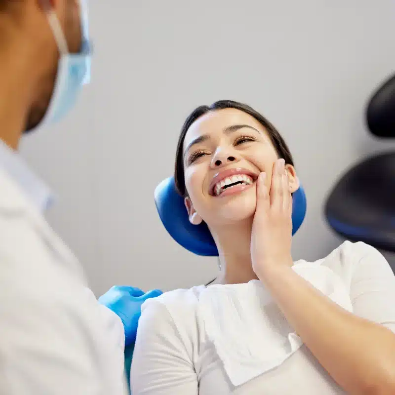 Woman smiling at dentist in clinic for cosmetic dentistry