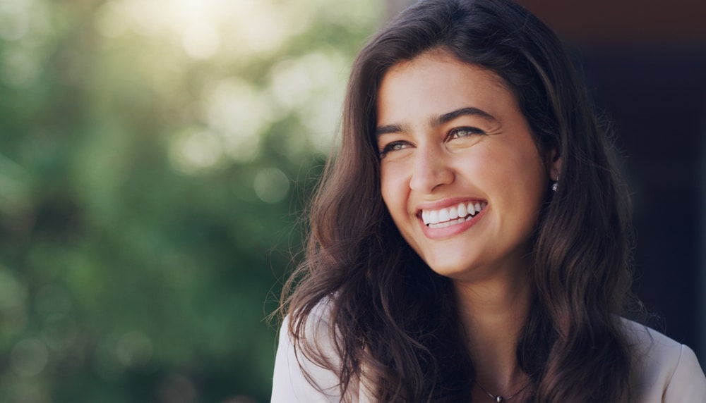 Joyful young woman smiling outdoors