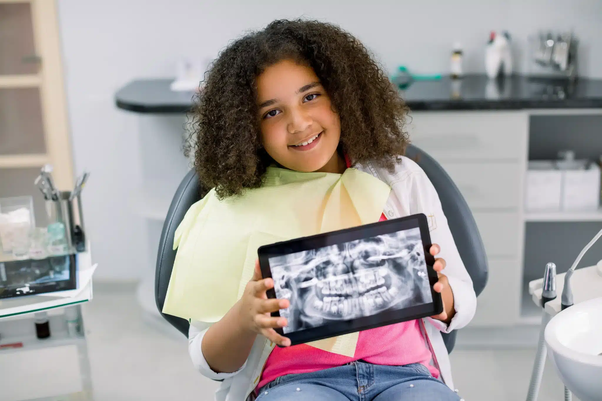 Young girl showing dental X-ray in pediatric dentist in fernley office